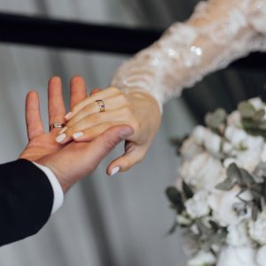 A,Bride,And,Groom,Are,Holding,Hands,,With,The,Bride
