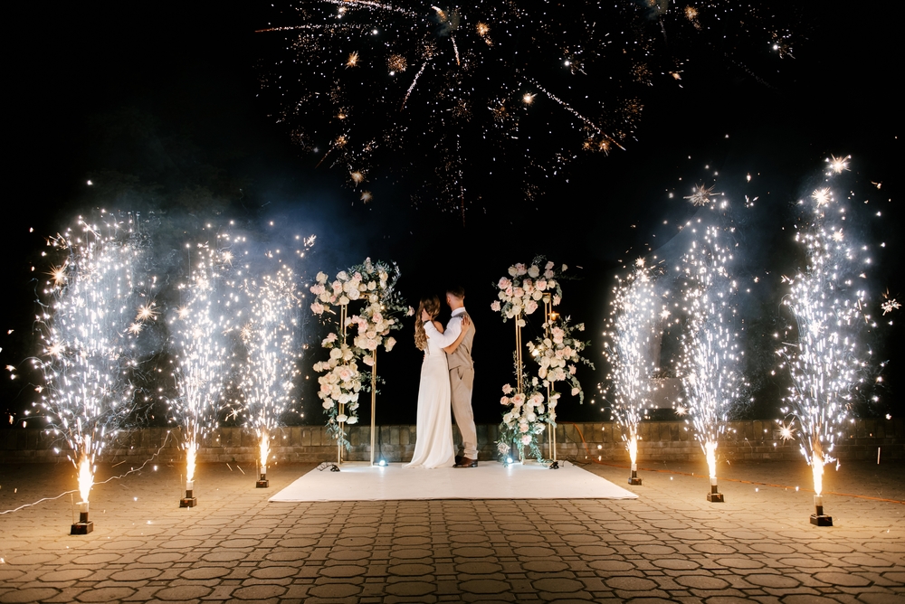 Young,Bride,And,Groom,Stand,Near,The,Wedding,Arch,At
